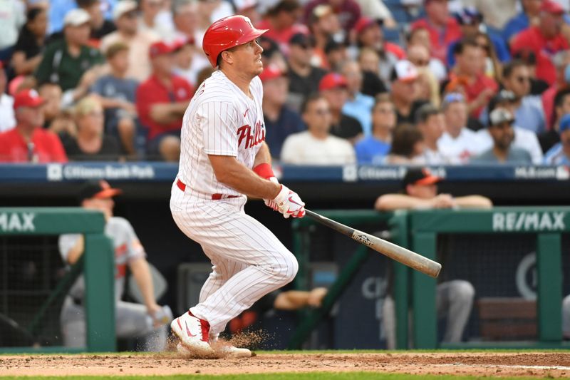 Jul 26, 2023; Philadelphia, Pennsylvania, USA; Philadelphia Phillies catcher J.T. Realmuto (10) hits a two RBI double during the fourth inning against the Baltimore Orioles at Citizens Bank Park. Mandatory Credit: Eric Hartline-USA TODAY Sports