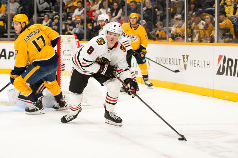 Jan 16, 2025; Nashville, Tennessee, USA; Chicago Blackhawks center Ryan Donato (8) controls the puck against the Nashville Predators  during the first period at Bridgestone Arena. Mandatory Credit: Steve Roberts-Imagn Images