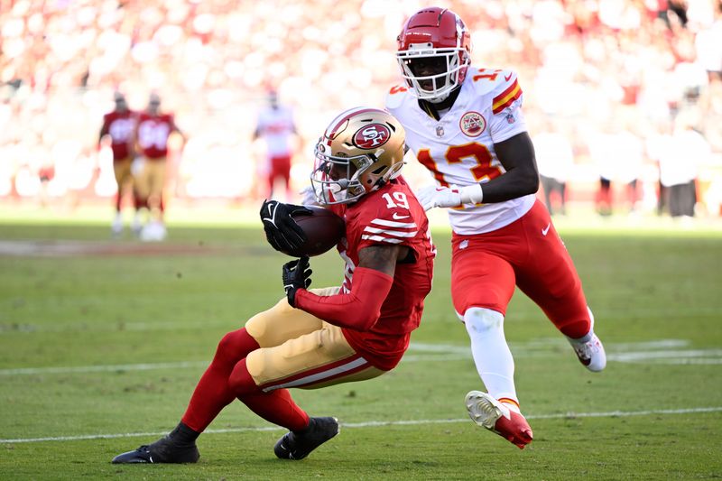 San Francisco 49ers wide receiver Jacob Cowing (19) catches a pass against Kansas City Chiefs safety Nazeeh Johnson (13) during the second half of an NFL football game in Santa Clara, Calif., Sunday, Oct. 20, 2024. (AP Photo/Eakin Howard)