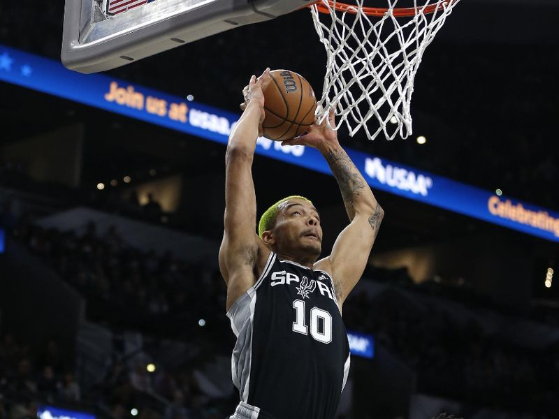 SAN ANTONIO, TX - DECEMBER 26: Jeremy Sochan #10 of the San Antonio Spurs attempts to dunk past Collin Sexton #2 of the Utah Jazz in the first half at AT&T Center on December 26, 2022 in San Antonio, Texas. NOTE TO USER: User expressly acknowledges and agrees that, by downloading and or using this photograph, User is consenting to terms and conditions of the Getty Images License Agreement. (Photo by Ronald Cortes/Getty Images)