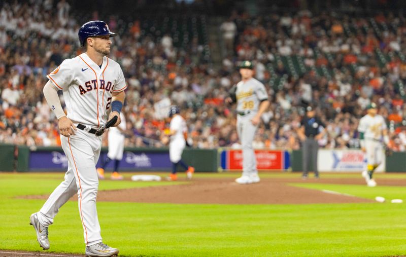 Sep 12, 2023; Houston, Texas, USA; Houston Astros third baseman Alex Bregman (2) walks to load the bases against the Oakland Athletics in the first inning at Minute Maid Park. Mandatory Credit: Thomas Shea-USA TODAY Sports