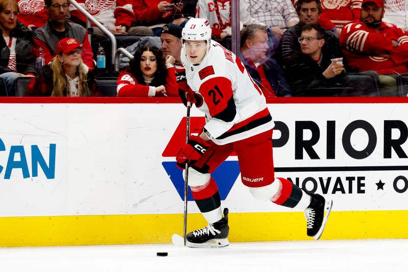Jan 12, 2026; Detroit, Michigan, USA;  Carolina Hurricanes defenseman Alexander Nikishin (21) skates with the puck in the first period against the Detroit Red Wings at Little Caesars Arena. Mandatory Credit: Rick Osentoski-Imagn Images