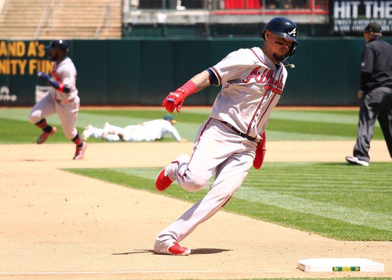 May 31, 2023; Oakland, California, USA; Atlanta Braves shortstop Orlando Arcia (11) rounds third base ahead of center fielder Michael Harris II (23) to score a run against the Oakland Athletics during the seventh inning at Oakland-Alameda County Coliseum. Mandatory Credit: Kelley L Cox-USA TODAY Sports