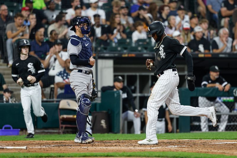 Aug 9, 2023; Chicago, Illinois, USA; Chicago White Sox center fielder Luis Robert Jr. (88) scores against the New York Yankees during the third inning at Guaranteed Rate Field. Mandatory Credit: Kamil Krzaczynski-USA TODAY Sports