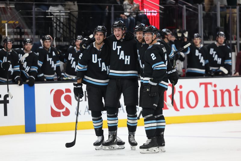 Oct 30, 2024; Salt Lake City, Utah, USA; Utah Hockey Club defenseman Maveric Lamoureux (center) celebrates a goal against the Calgary Flames during the second period at Delta Center. Mandatory Credit: Rob Gray-Imagn Images