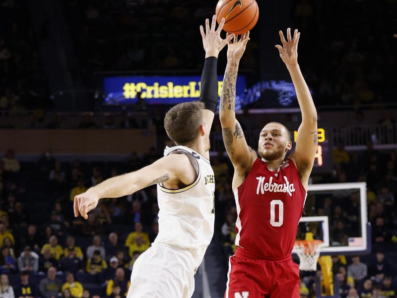 Feb 8, 2023; Ann Arbor, Michigan, USA;  Nebraska Cornhuskers guard C.J. Wilcher (0) shoots on Michigan Wolverines guard Joey Baker (15) in the second half at Crisler Center. Mandatory Credit: Rick Osentoski-USA TODAY Sports