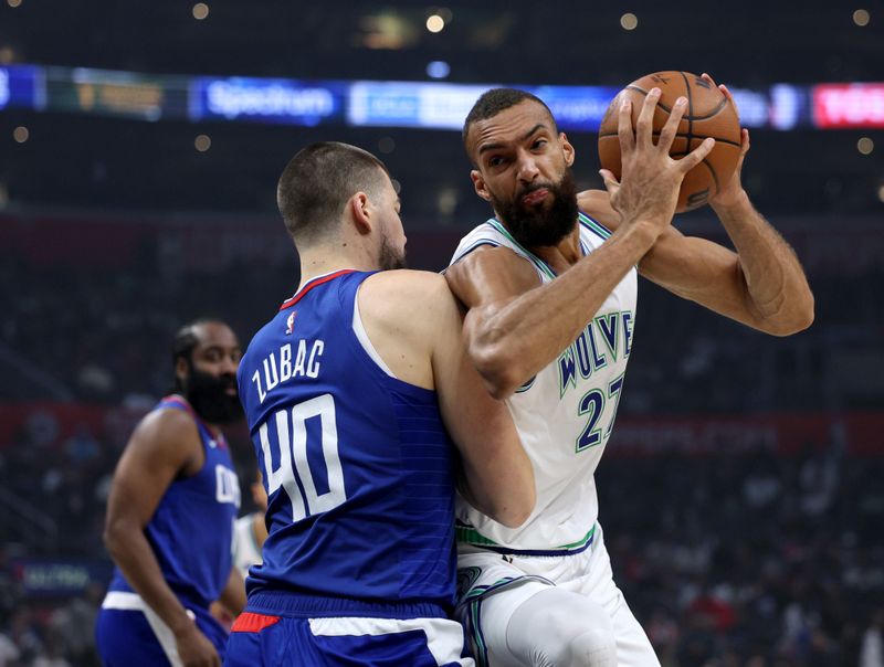 LOS ANGELES, CALIFORNIA - MARCH 12: Rudy Gobert #27 of the Minnesota Timberwolves pivots in front of Ivica Zubac #40 of the LA Clippers during the first half at Crypto.com Arena on March 12, 2024 in Los Angeles, California. (Photo by Harry How/Getty Images)