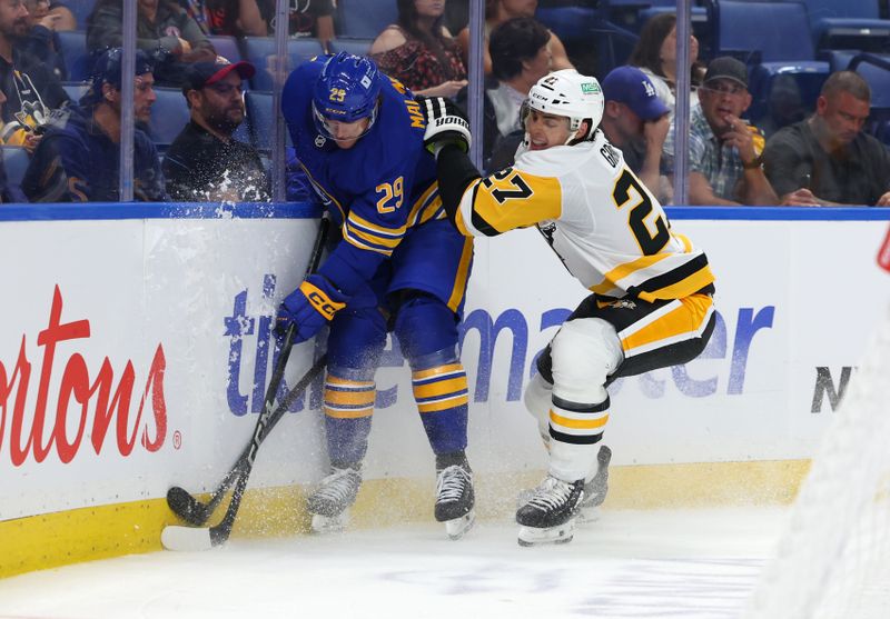 Sep 21, 2024; Buffalo, New York, USA;  Pittsburgh Penguins defenseman Ryan Graves (27) checks Buffalo Sabres left wing Beck Malenstyn (29) as he goes after a loose puck during the second period at KeyBank Center. Mandatory Credit: Timothy T. Ludwig-Imagn Images