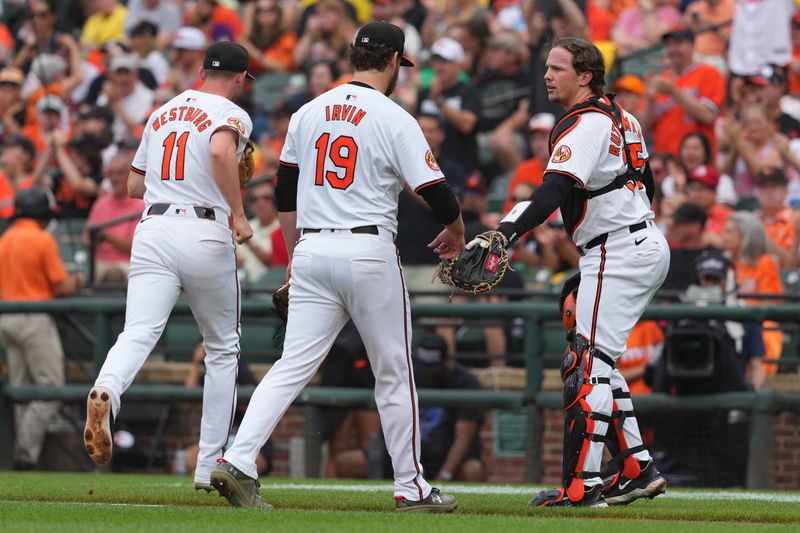 May 27, 2024; Baltimore, Maryland, USA; Baltimore Orioles starting pitcher Cole Irvin (19) greeted by catcher Adley Rutschman (35) at the end of the first inning against the Boston Red Sox at Oriole Park at Camden Yards. Mandatory Credit: Mitch Stringer-USA TODAY Sports