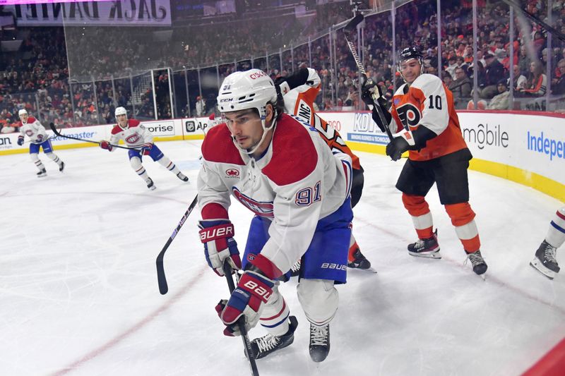 Jan 10, 2024; Philadelphia, Pennsylvania, USA; Montreal Canadiens center Sean Monahan (91) clears the puck against the Philadelphia Flyers during third period at Wells Fargo Center. Mandatory Credit: Eric Hartline-USA TODAY Sports