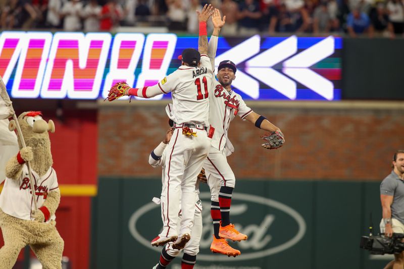 Aug 16, 2023; Atlanta, Georgia, USA; Atlanta Braves shortstop Orlando Arcia (11) and left fielder Eddie Rosario (8) celebrate after a victory against the New York Yankees at Truist Park. Mandatory Credit: Brett Davis-USA TODAY Sports
