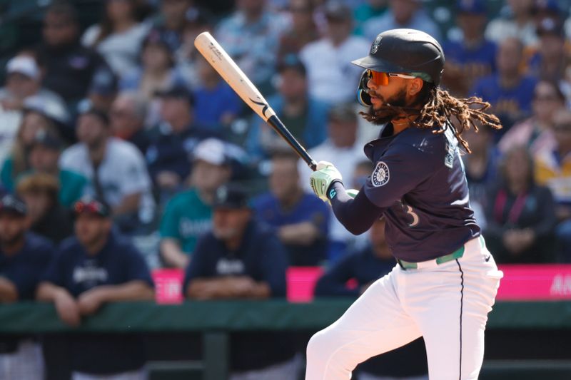 Sep 19, 2024; Seattle, Washington, USA; Seattle Mariners shortstop J.P. Crawford (3) hits an RBI-single against the New York Yankees during the first inning at T-Mobile Park. Mandatory Credit: Joe Nicholson-Imagn Images