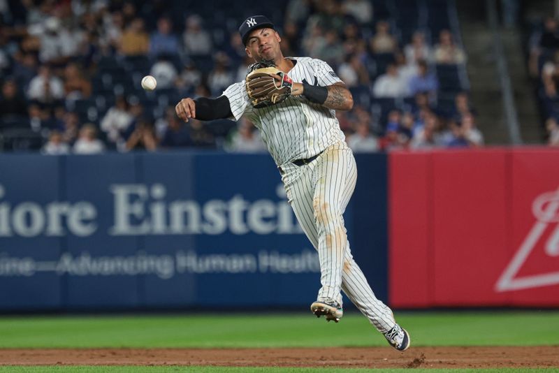 Sep 10, 2024; Bronx, New York, USA;  New York Yankees second baseman Gleyber Torres (25) throws the ball to first base for an out during the ninth inning against the Kansas City Royals at Yankee Stadium. Mandatory Credit: Vincent Carchietta-Imagn Images