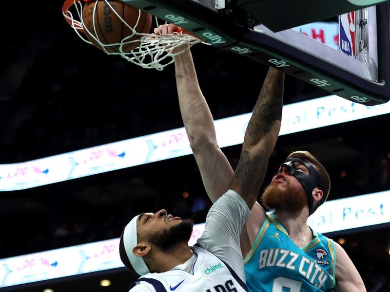 CHARLOTTE, NORTH CAROLINA - APRIL 09: Davis Bertans #9 of the Charlotte Hornets dunks the ball over Daniel Gafford #21 of the Dallas Mavericks during the first half of an NBA game at Spectrum Center on April 09, 2024 in Charlotte, North Carolina. NOTE TO USER: User expressly acknowledges and agrees that, by downloading and or using this photograph, User is consenting to the terms and conditions of the Getty Images License Agreement. (Photo by David Jensen/Getty Images)