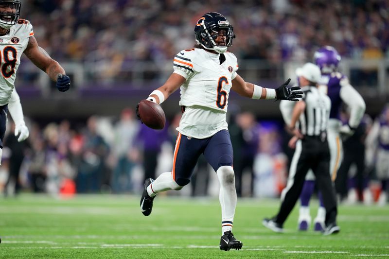 Chicago Bears cornerback Kyler Gordon (6) celebrates after an interception during the second half of an NFL football game against the Minnesota Vikings, Monday, Nov. 27, 2023, in Minneapolis. (AP Photo/Abbie Parr)