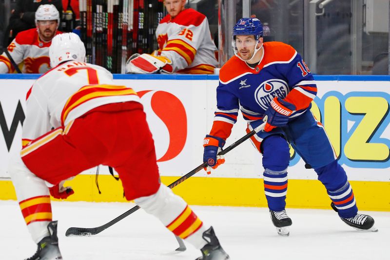 Oct 13, 2024; Edmonton, Alberta, CAN; Edmonton Oilers forward Zach Hyman (18) looks to make a pass in front of Calgary Flames defensemen Kevin Bahl (7) during the first period at Rogers Place. Mandatory Credit: Perry Nelson-Imagn Images