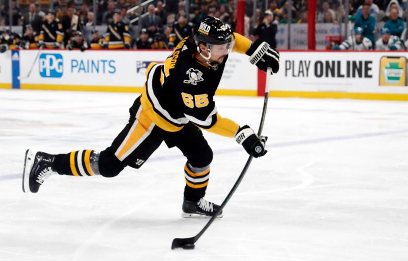 Mar 14, 2024; Pittsburgh, Pennsylvania, USA; Pittsburgh Penguins defenseman Erik Karlsson (65) shoots the puck against the San Jose Sharks during the first period at PPG Paints Arena. Mandatory Credit: Charles LeClaire-USA TODAY Sports