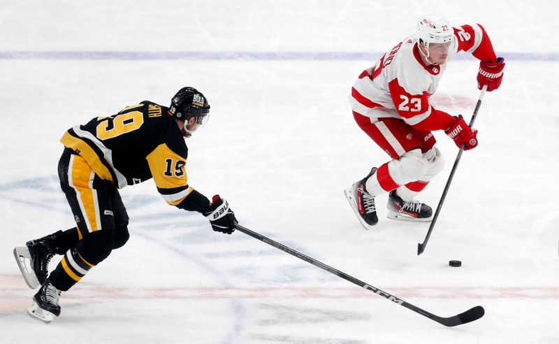 Mar 17, 2024; Pittsburgh, Pennsylvania, USA;  Detroit Red Wings left wing Lucas Raymond (23) moves the puck against Pittsburgh Penguins right wing Reilly Smith (19) during the third period at PPG Paints Arena.  Pittsburgh won 6-3.Mandatory Credit: Charles LeClaire-USA TODAY Sports