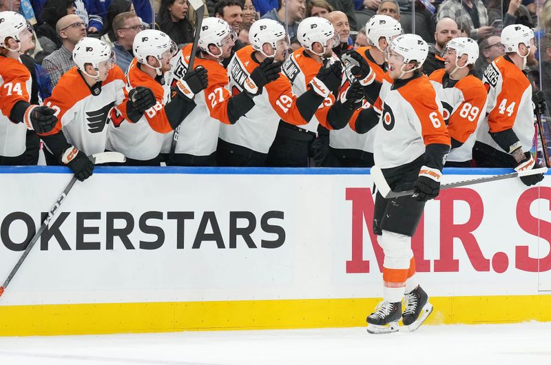 Feb 15, 2024; Toronto, Ontario, CAN; Philadelphia Flyers defenseman Travis Sanheim (6) celebrates at the bench after scoring a goal against the Toronto Maple Leafs during the first period at Scotiabank Arena. Mandatory Credit: Nick Turchiaro-USA TODAY Sports