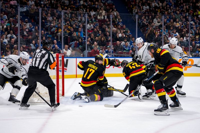 Mar 25, 2024; Vancouver, British Columbia, CAN; Vancouver Canucks defenseman Filip Hronek (17), goalie Casey DeSmith (29), defenseman Quinn Hughes (43) and forward Sam Lafferty (18) watch as Los Angeles Kings forward Anze Kopitar (11) scores in the second period  at Rogers Arena. Mandatory Credit: Bob Frid-USA TODAY Sports