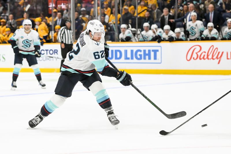 Oct 15, 2024; Nashville, Tennessee, USA;  Seattle Kraken defenseman Brandon Montour (62) takes shot on goal against the Nashville Predators during the second period at Bridgestone Arena. Mandatory Credit: Steve Roberts-Imagn Images