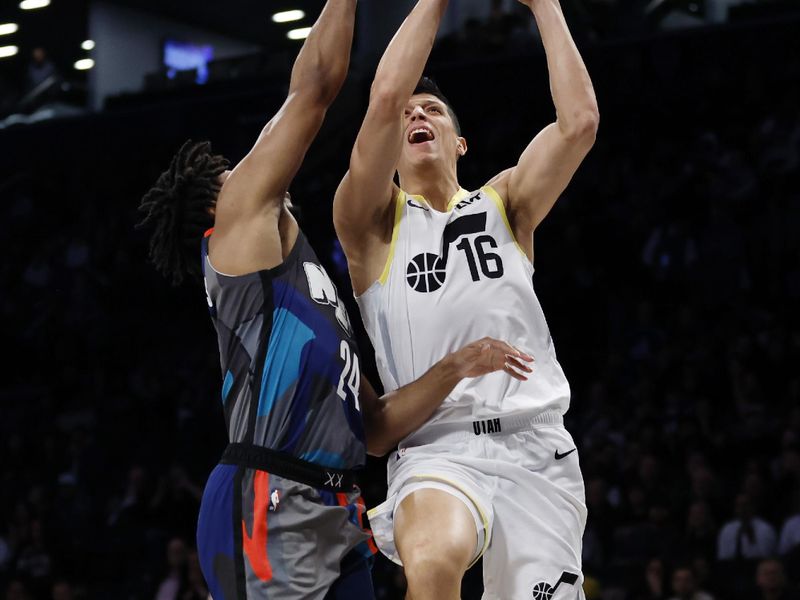 NEW YORK, NEW YORK - JANUARY 29: Simone Fontecchio #16 of the Utah Jazz goes to the basket as Cam Thomas #24 of the Brooklyn Nets defends during the first half at Barclays Center on January 29, 2024 in the Brooklyn borough of New York City. NOTE TO USER: User expressly acknowledges and agrees that, by downloading and/or using this Photograph, user is consenting to the terms and conditions of the Getty Images License Agreement. (Photo by Sarah Stier/Getty Images)