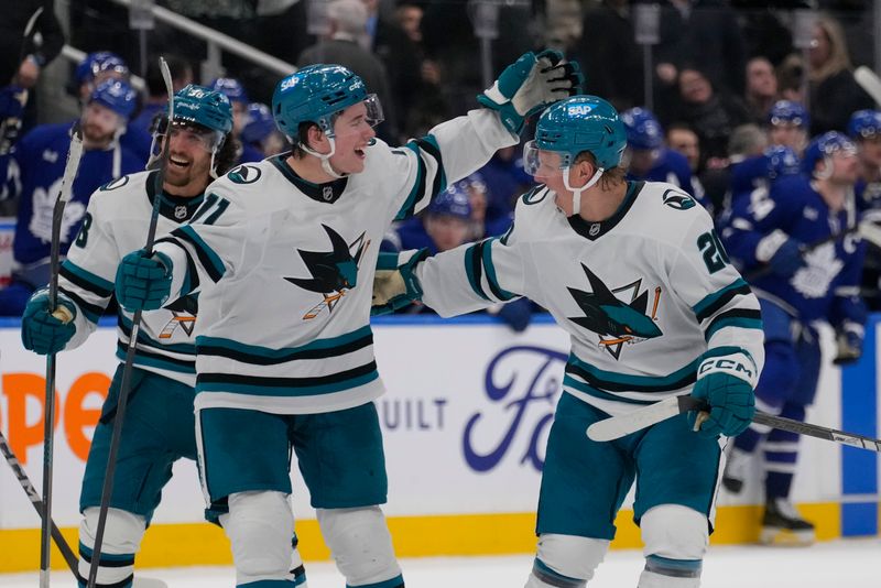 Mar 3, 2025; Toronto, Ontario, CAN; San Jose Sharks forward Fabian Zetterlund (20) celebrates his game winning goal over the Toronto Maple Leafs with San Jose Sharks forward Macklin Celebrini (71) during the overtime shoot out at Scotiabank Arena. Mandatory Credit: John E. Sokolowski-Imagn Images
