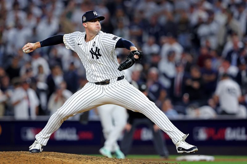 Oct 30, 2024; New York, New York, USA; New York Yankees pitcher Clay Holmes (35) pitches seventh inning against the Los Angeles Dodgers in game four of the 2024 MLB World Series at Yankee Stadium. Mandatory Credit: Brad Penner-Imagn Images