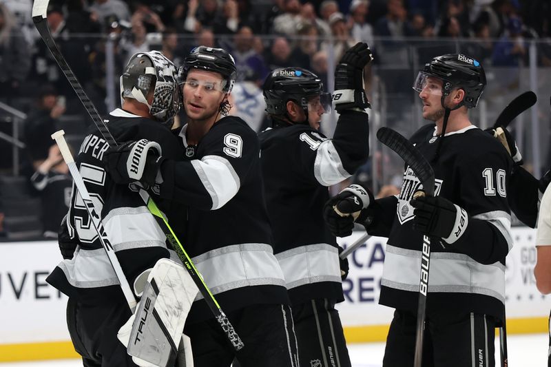 Oct 30, 2024; Los Angeles, California, USA;  Los Angeles Kings goaltender Darcy Kuemper (35, left) celebrates a victory wtih right wing Adrian Kempe (9) after defeating the Vegas Golden Knights 6-3 at Crypto.com Arena. Mandatory Credit: Kiyoshi Mio-Imagn Images