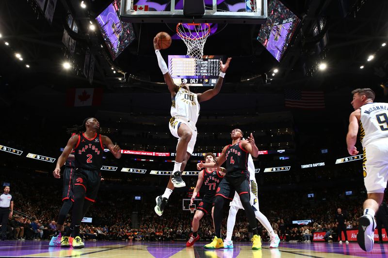 TORONTO, CANADA - DECEMBER 3: Bennedict Mathurin #00 of the Indiana Pacers drives to the basket during the game against the Toronto Raptors during the Emirates NBA Cup game on December 3, 2024 at the Scotiabank Arena in Toronto, Ontario, Canada.  NOTE TO USER: User expressly acknowledges and agrees that, by downloading and or using this Photograph, user is consenting to the terms and conditions of the Getty Images License Agreement.  Mandatory Copyright Notice: Copyright 2024 NBAE (Photo by Vaughn Ridley/NBAE via Getty Images)