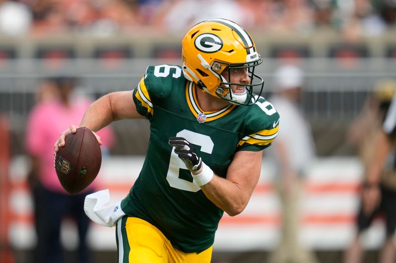 Green Bay Packers quarterback Sean Clifford scrambles during the first half of an NFL preseason football game against the Cleveland Browns, Saturday, Aug. 10, 2024, in Cleveland. (AP Photo/Sue Ogrocki)