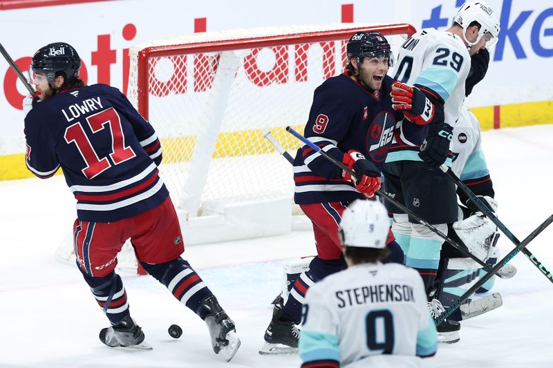 Jan 16, 2025; Winnipeg, Manitoba, CAN; Winnipeg Jets left wing Alex Iafallo (9) reacts to a goal by Winnipeg Jets defenseman Dylan DeMelo (2) (not shown) against the Seattle Kraken in the third period at Canada Life Centre. Mandatory Credit: James Carey Lauder-Imagn Images