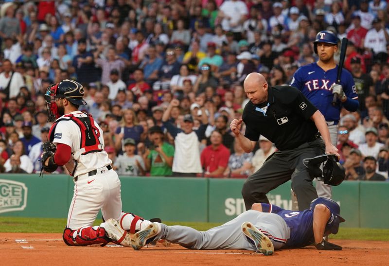 Aug 12, 2024; Boston, Massachusetts, USA; Texas Rangers shortstop Corey Seager (5) tagged out at home plate by Boston Red Sox catcher Connor Wong (12) in the first inning at Fenway Park. Mandatory Credit: David Butler II-USA TODAY Sports