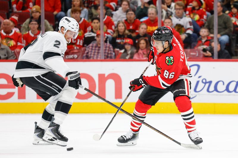 Oct 26, 2025; Chicago, Illinois, USA; Chicago Blackhawks center Teuvo Teravainen (86) battles for the puck with Los Angeles Kings defenseman Brian Dumoulin (2) during the first period at United Center. Mandatory Credit: Kamil Krzaczynski-Imagn Images
