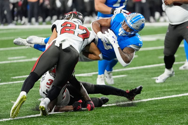 Detroit Lions running back David Montgomery (5) is stopped by Tampa Bay Buccaneers cornerback Zyon McCollum (27) during the first half of an NFL football game, Sunday, Sept. 15, 2024, in Detroit. (AP Photo/Paul Sancya)