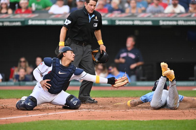 Sep 3, 2023; Cleveland, Ohio, USA; Tampa Bay Rays center fielder Jose Siri (22) is safe at home as Cleveland Guardians catcher Bo Naylor (23) is late with the tag during the eighth inning at Progressive Field. Mandatory Credit: Ken Blaze-USA TODAY Sports