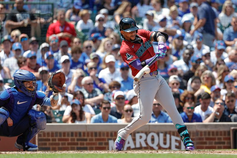 Jul 19, 2024; Chicago, Illinois, USA; Arizona Diamondbacks second baseman Ketel Marte (4) singles against the Chicago Cubs during the third inning at Wrigley Field. Mandatory Credit: Kamil Krzaczynski-USA TODAY Sports