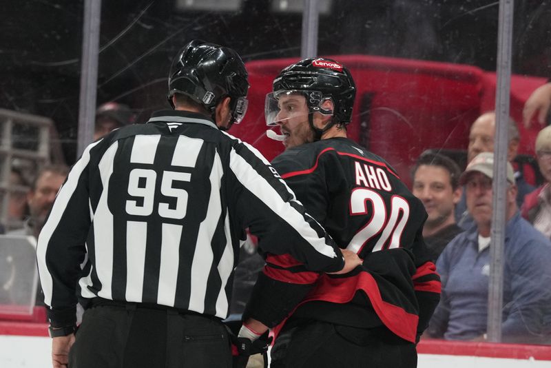 May 20, 2025; Raleigh, North Carolina, USA;  Carolina Hurricanes forward Sebastian Aho (20) talks with the refere during the first period against the Florida Panthers in game one of the Eastern Conference Final of the 2025 Stanley Cup Playoffs at Lenovo Center. Mandatory Credit: James Guillory-Imagn Images