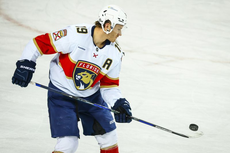 Dec 14, 2024; Calgary, Alberta, CAN; Florida Panthers left wing Matthew Tkachuk (19) controls the puck during the warmup period against the Calgary Flames at Scotiabank Saddledome. Mandatory Credit: Sergei Belski-Imagn Images