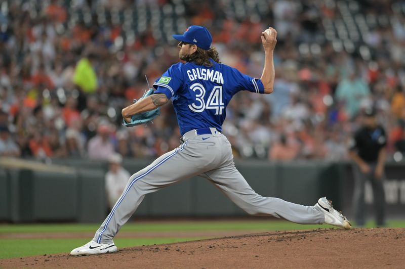 Aug 23, 2023; Baltimore, Maryland, USA;  Toronto Blue Jays starting pitcher Kevin Gausman (34) throws a second inning pitch against the Baltimore Orioles at Oriole Park at Camden Yards. Mandatory Credit: Tommy Gilligan-USA TODAY Sports