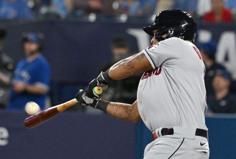 Aug 26, 2023; Toronto, Ontario, CAN;  Cleveland Guardians designated hitter Jose Ramirez (11) hits a solo home run against the Toronto Blue Jays in the first inning at Rogers Centre. Mandatory Credit: Dan Hamilton-USA TODAY Sports