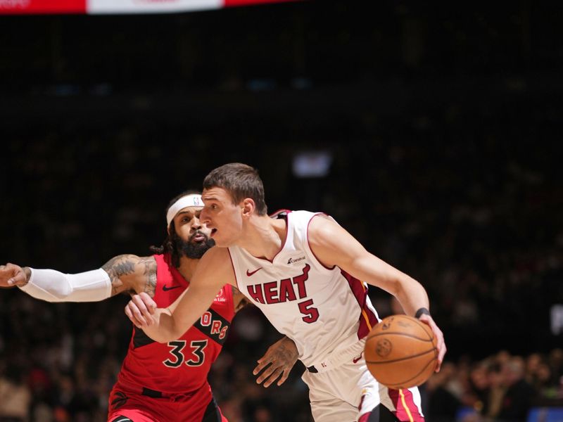 TORONTO, CANADA - JANUARY 17: Nikola Jovic #5 of the Miami Heat dribbles the ball during the game against the Toronto Raptors on January 17, 2024 at the Scotiabank Arena in Toronto, Ontario, Canada.  NOTE TO USER: User expressly acknowledges and agrees that, by downloading and or using this Photograph, user is consenting to the terms and conditions of the Getty Images License Agreement.  Mandatory Copyright Notice: Copyright 2024 NBAE (Photo by Mark Blinch/NBAE via Getty Images)