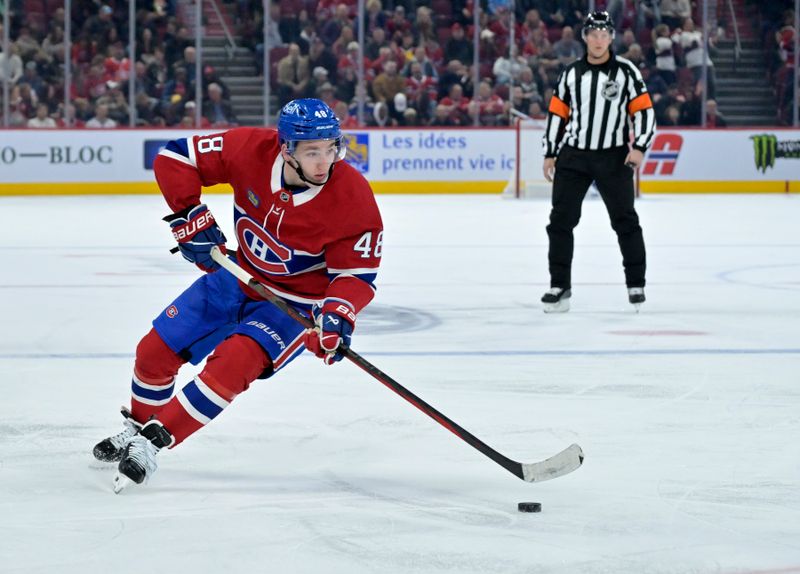 Oct 26, 2024; Montreal, Quebec, CAN; Montreal Canadiens defenseman Lane Hutson (48) plays the puck against the St.Louis Bluesduring the third period  at the Bell Centre. Mandatory Credit: Eric Bolte-Imagn Images