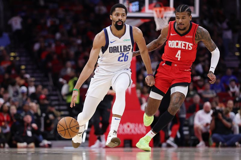 HOUSTON, TEXAS - JANUARY 01: Spencer Dinwiddie #26 of the Dallas Mavericks dribbles against Jalen Green #4 of the Houston Rockets  during the first half at Toyota Center on January 01, 2025 in Houston, Texas. NOTE TO USER: User expressly acknowledges and agrees that, by downloading and or using this photograph, User is consenting to the terms and conditions of the Getty Images License Agreement. (Photo by Alex Slitz/Getty Images)