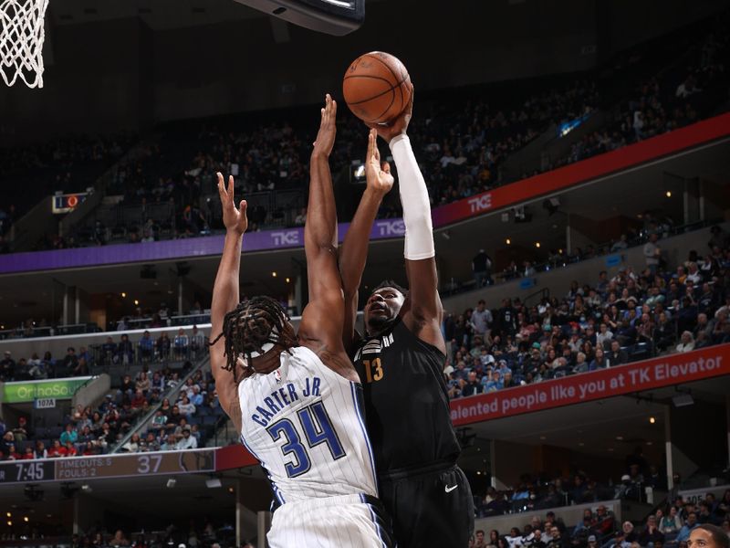 MEMPHIS, TN - JANUARY 26:  Jaren Jackson Jr. #13 of the Memphis Grizzlies drives to the basket during the game against the Orlando Magic on January 26, 2024 at FedExForum in Memphis, Tennessee. NOTE TO USER: User expressly acknowledges and agrees that, by downloading and or using this photograph, User is consenting to the terms and conditions of the Getty Images License Agreement. Mandatory Copyright Notice: Copyright 2024 NBAE (Photo by Joe Murphy/NBAE via Getty Images)