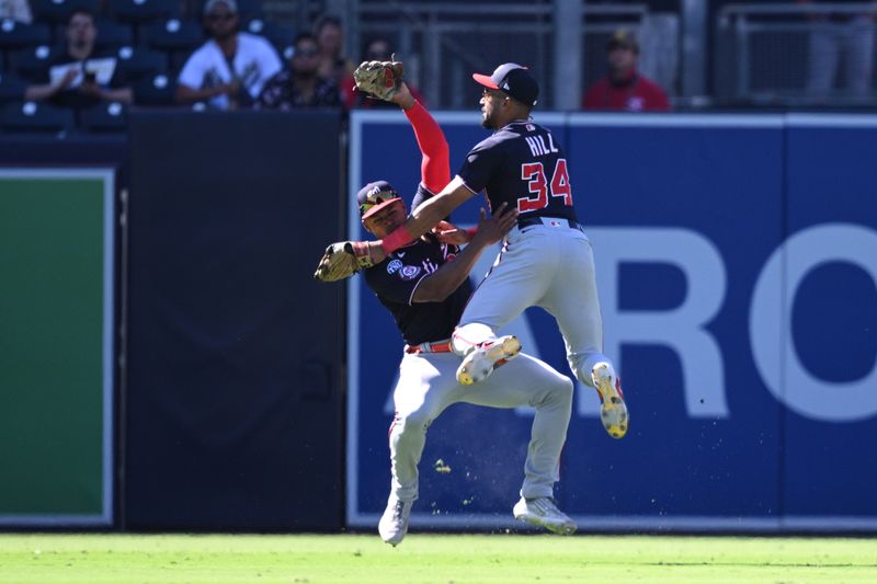 Jun 25, 2023; San Diego, California, USA; Washington Nationals center fielder Derek Hill (34) collides with left fielder Stone Garrett (36) after making a game-ending catch in the ninth inning against the San Diego Padres at Petco Park. Mandatory Credit: Orlando Ramirez-USA TODAY Sports