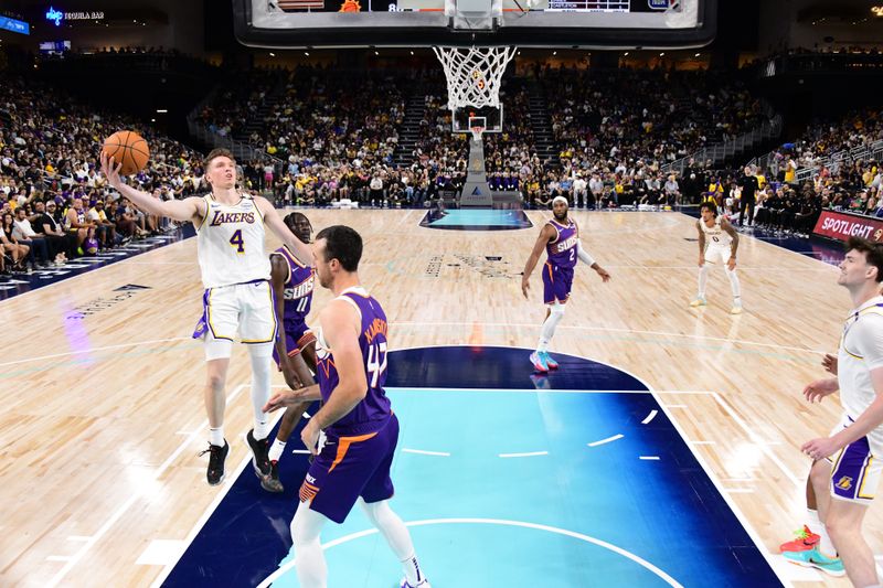 LOS ANGELES, CA - OCTOBER 6: Dalton Knecht #4 of the Los Angeles Lakers drives to the basket during the game against the Phoenix Suns on October 6, 2024 at Acrisure Arena in Palm Springs, California. NOTE TO USER: User expressly acknowledges and agrees that, by downloading and/or using this Photograph, user is consenting to the terms and conditions of the Getty Images License Agreement. Mandatory Copyright Notice: Copyright 2024 NBAE (Photo by Adam Pantozzi/NBAE via Getty Images)