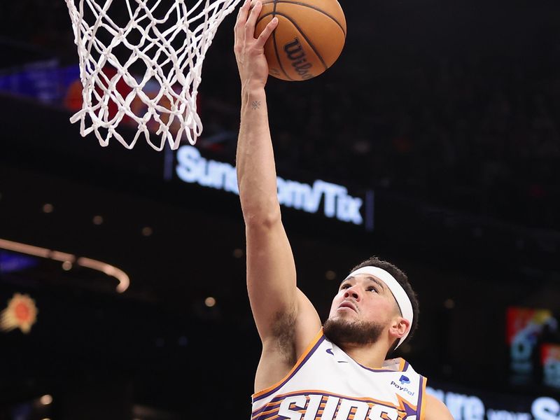PHOENIX, ARIZONA - DECEMBER 25: Devin Booker #1 of the Phoenix Suns lays up a shot against the Dallas Mavericks during the second half of the NBA game at Footprint Center on December 25, 2023 in Phoenix, Arizona. The Mavericks defeated the Suns 128-114. NOTE TO USER: User expressly acknowledges and agrees that, by downloading and or using this photograph, User is consenting to the terms and conditions of the Getty Images License Agreement.  (Photo by Christian Petersen/Getty Images)