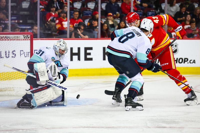 Sep 23, 2025; Calgary, Alberta, CAN; Seattle Kraken goaltender Philipp Grubauer (31) makes a save against Calgary Flames right wing Adam Klapka (43) during the second period at Scotiabank Saddledome. Mandatory Credit: Sergei Belski-Imagn Images
