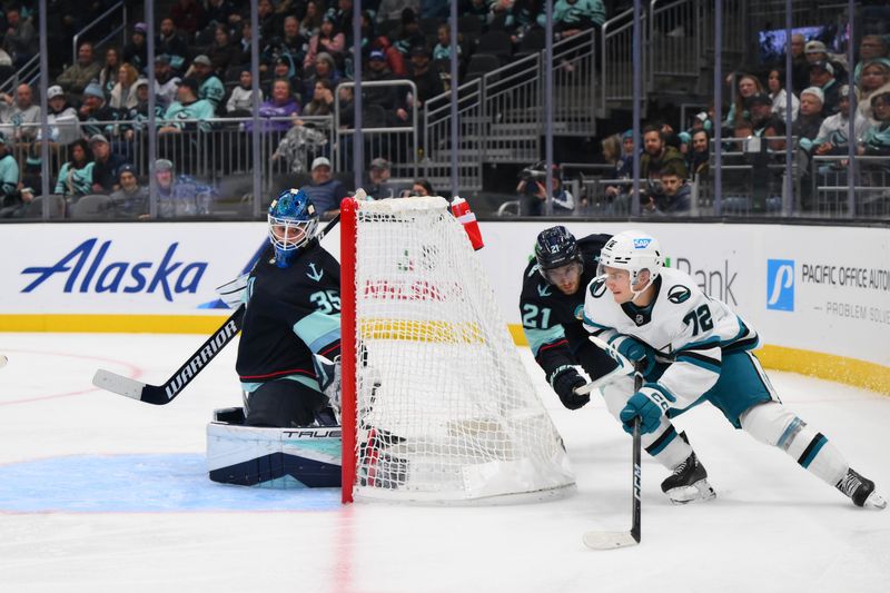 Nov 22, 2023; Seattle, Washington, USA; San Jose Sharks center William Eklund (72) moves the puck around the goal while defended by Seattle Kraken center Alex Wennberg (21) during the third period at Climate Pledge Arena. Mandatory Credit: Steven Bisig-USA TODAY Sports